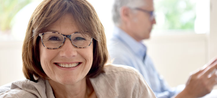 Lady listens for hearing aid feedback, which often presents as a whistling or hissing sound.