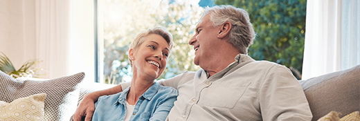 Image of that same couple on the couch smiling