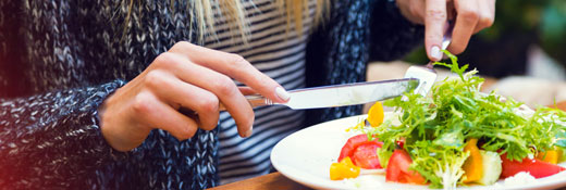 Image of a woman eating a salad
